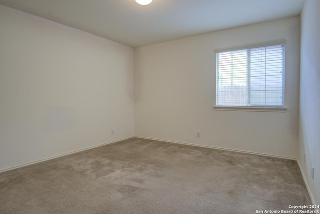 spare room with light carpet