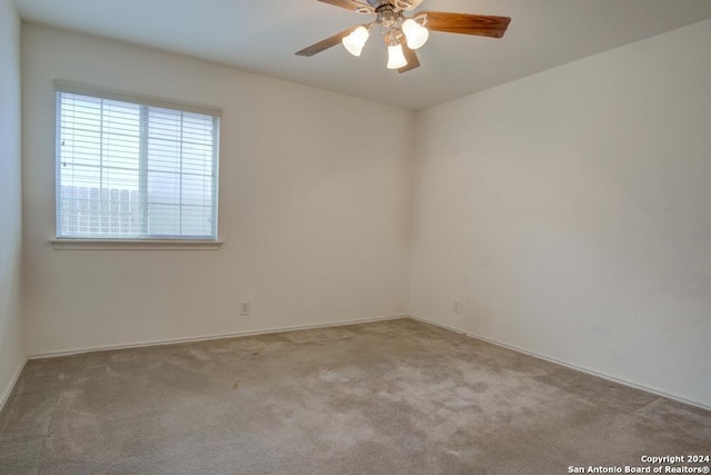 empty room with light carpet and ceiling fan