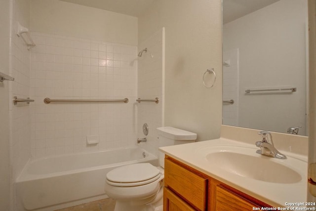 full bathroom featuring toilet, tiled shower / bath, vanity, and tile patterned flooring