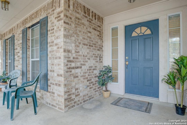 view of exterior entry featuring a porch