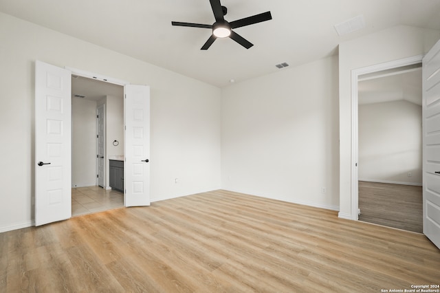 unfurnished bedroom with lofted ceiling, light hardwood / wood-style flooring, a closet, and ceiling fan