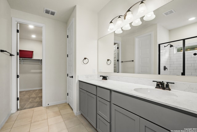 bathroom with vanity, tile patterned flooring, and walk in shower