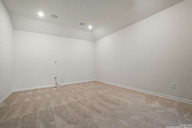 unfurnished room with lofted ceiling and carpet floors