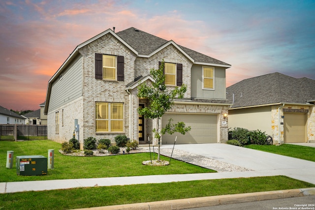 view of front facade with a garage and a lawn