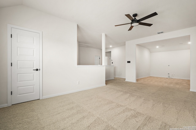 unfurnished living room with vaulted ceiling, light carpet, and ceiling fan