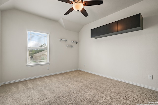 carpeted empty room featuring lofted ceiling and ceiling fan