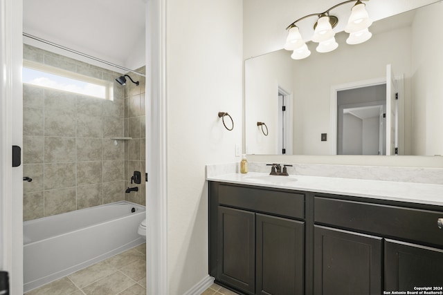 full bathroom featuring vanity, tiled shower / bath, toilet, and tile patterned flooring