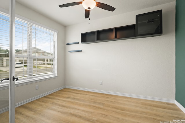 empty room with light hardwood / wood-style flooring and ceiling fan