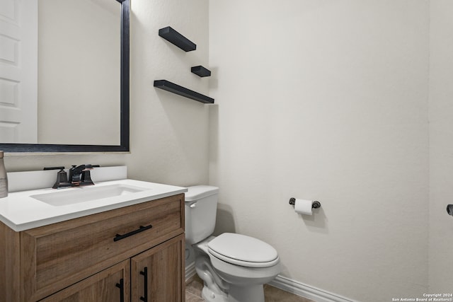 bathroom featuring toilet, vanity, and tile patterned floors