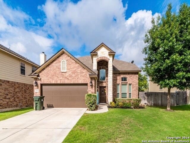 view of front of property with a front lawn and a garage