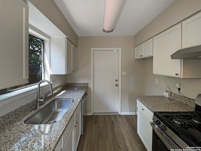 kitchen featuring white cabinets, light stone counters, dark hardwood / wood-style flooring, stainless steel range with gas cooktop, and sink