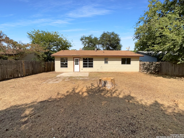 back of property with a patio