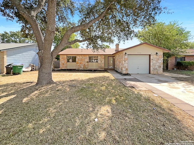 single story home featuring a front lawn and a garage