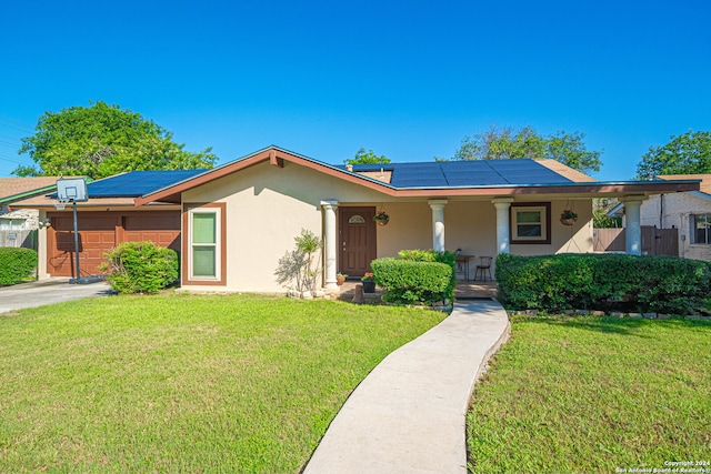 ranch-style house featuring solar panels, a porch, a front lawn, and a garage