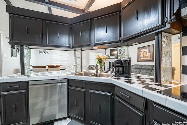 kitchen with tile countertops, kitchen peninsula, dishwasher, and sink