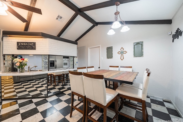 dining space featuring beamed ceiling and high vaulted ceiling