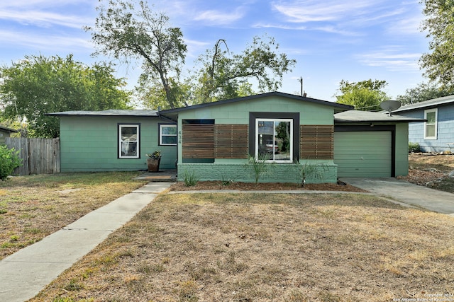 single story home featuring a front yard and a garage