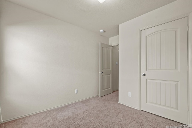 unfurnished bedroom with light carpet