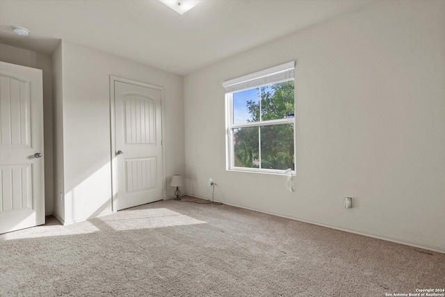 unfurnished bedroom featuring light colored carpet