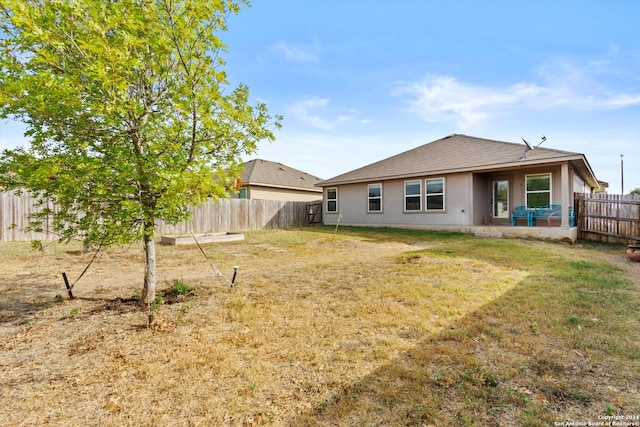 rear view of property with a yard