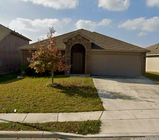 view of front of house featuring a garage and a front lawn