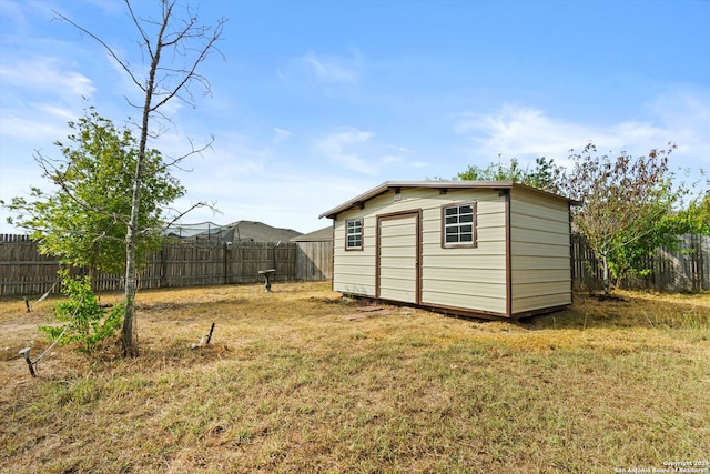 view of outdoor structure featuring a lawn