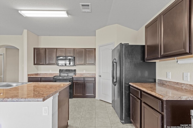 kitchen with black appliances, sink, dark brown cabinetry, lofted ceiling, and light tile patterned floors