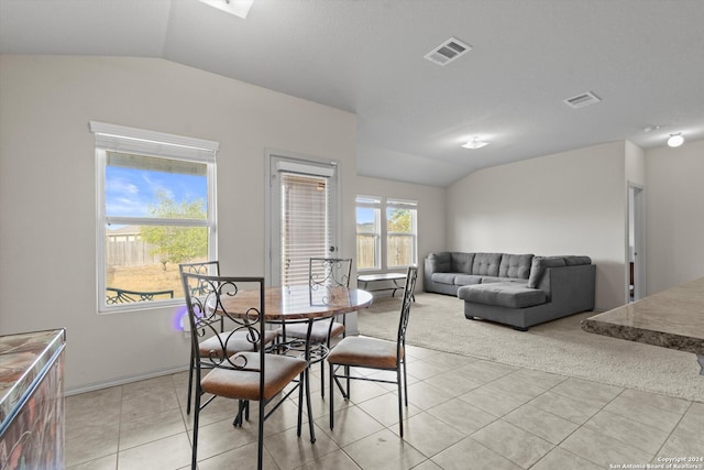 tiled dining area with lofted ceiling