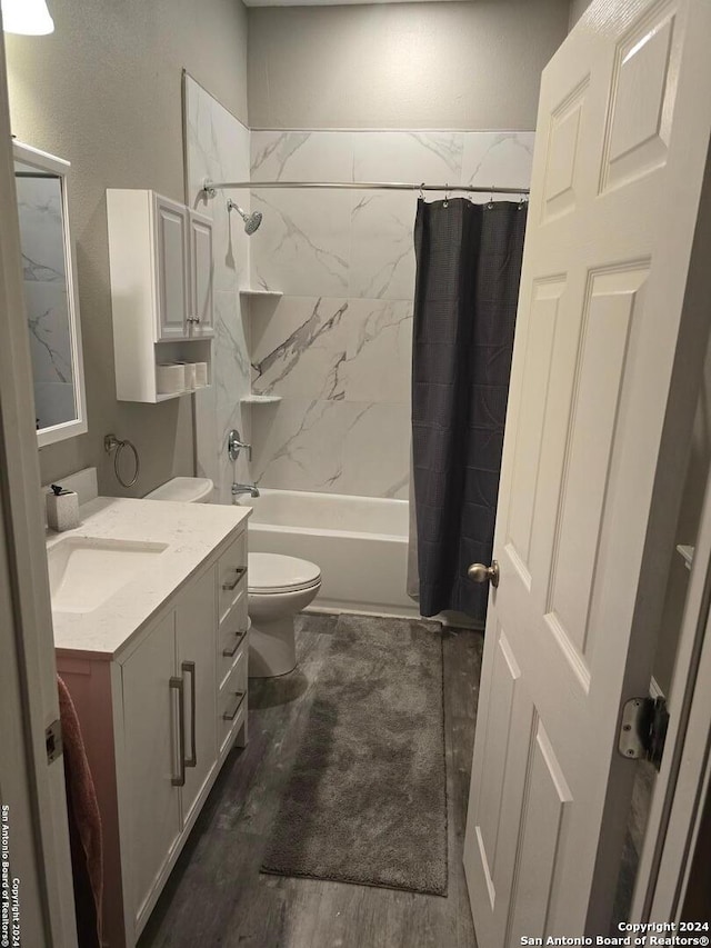 full bathroom with vanity, hardwood / wood-style flooring, toilet, and shower / bathtub combination with curtain