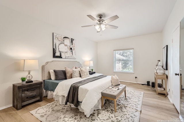 bedroom with light hardwood / wood-style flooring and ceiling fan