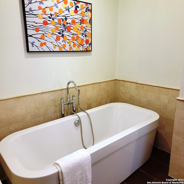 bathroom with tile walls and a washtub