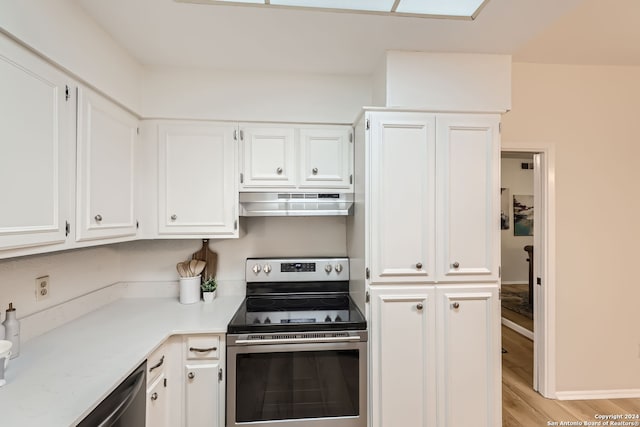 kitchen with white cabinetry, stainless steel electric stove, and light wood-type flooring