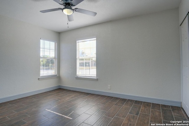 empty room featuring dark hardwood / wood-style floors and ceiling fan