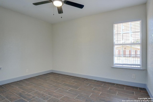 unfurnished room with ceiling fan and dark hardwood / wood-style floors