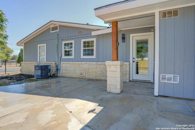 doorway to property featuring a patio area and central AC unit