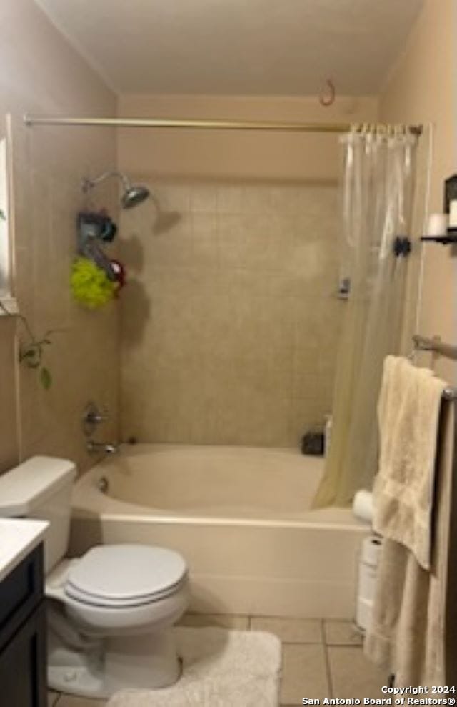 full bathroom with toilet, vanity, tile patterned flooring, and shower / bathtub combination with curtain