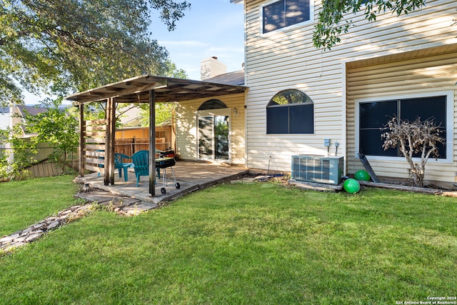 view of yard with central air condition unit and a patio area