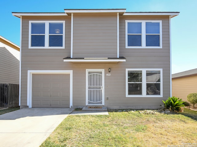 view of front of house featuring a front yard and a garage