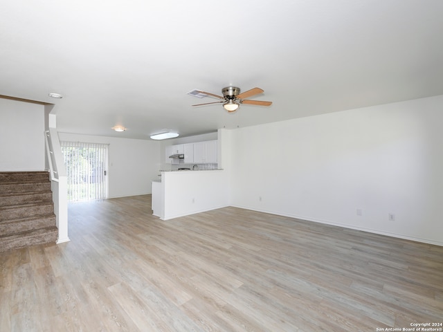 unfurnished living room with light hardwood / wood-style floors and ceiling fan