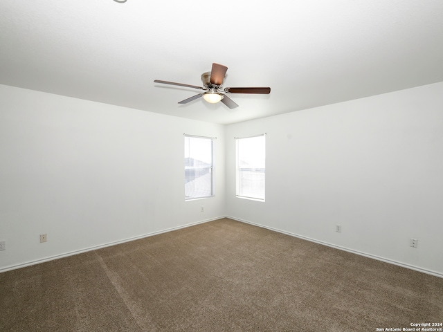 carpeted spare room with ceiling fan