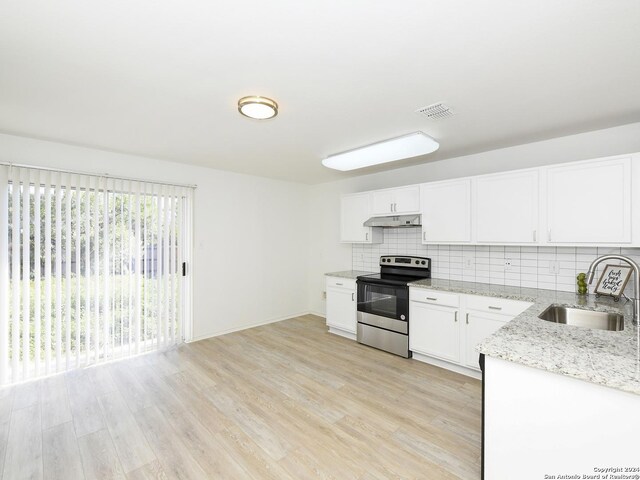 kitchen featuring stainless steel range with electric stovetop, a sink, under cabinet range hood, light stone counters, and backsplash