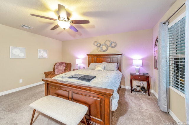 bedroom featuring light carpet and ceiling fan