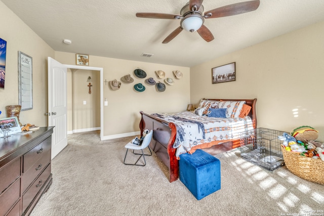 carpeted bedroom with a textured ceiling and ceiling fan