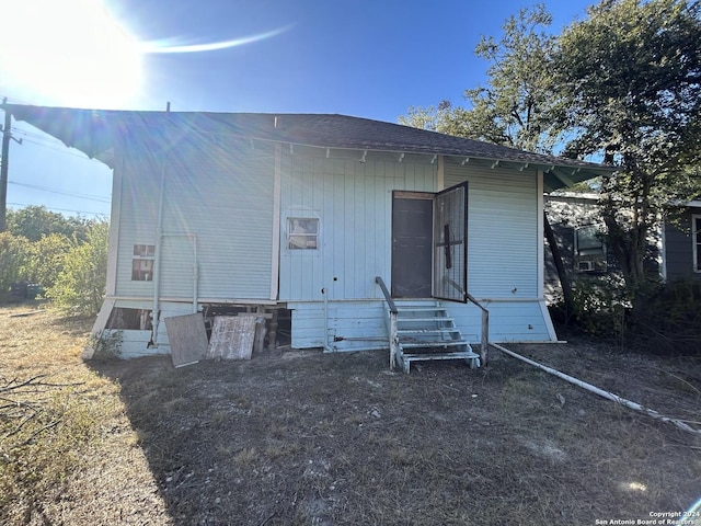 9446 Espada, San Antonio, TX 78214 - back of property featuring a shingled roof and entry steps