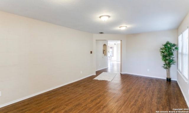 unfurnished room featuring dark hardwood / wood-style floors