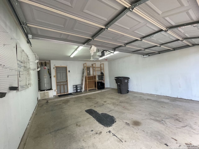 garage with a garage door opener, electric panel, and gas water heater