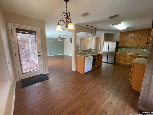 kitchen with stainless steel fridge, hanging light fixtures, white dishwasher, dark hardwood / wood-style floors, and ceiling fan with notable chandelier