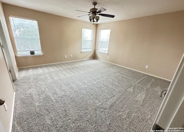 empty room featuring carpet flooring and ceiling fan