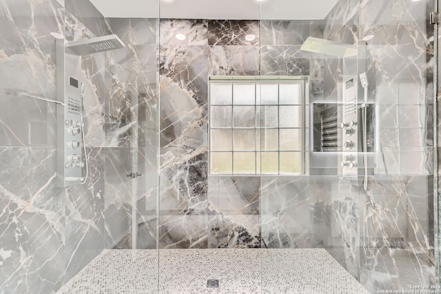 bathroom featuring a tile shower and tile walls