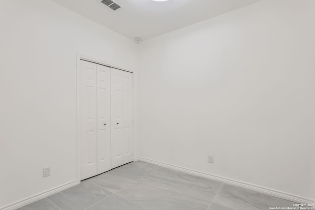 unfurnished bedroom with a closet